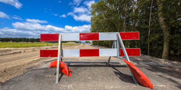 Red and white no entry roadblock on a small asphalt country road