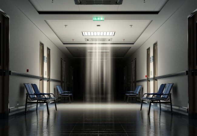 Long dark hospital corridor with rooms and blue seats 3D rendering. Empty accident and emergency interior with bright lights lighting the hall from the ceiling